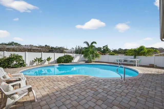 a view of a swimming pool with a patio