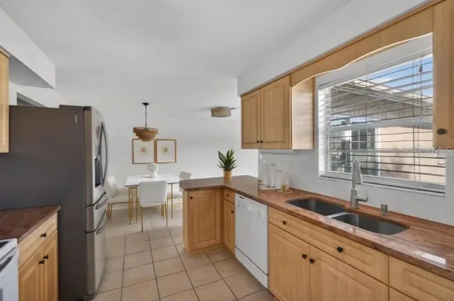 a kitchen with a sink cabinets and window