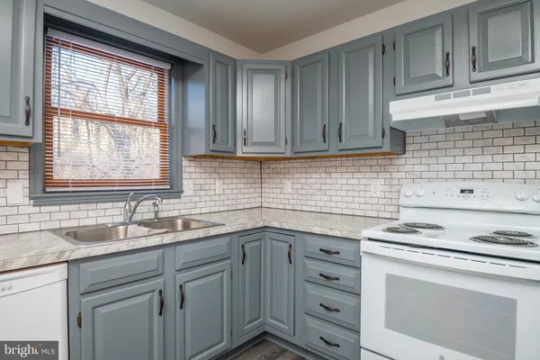 a kitchen with appliances cabinets and a window