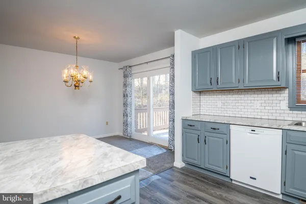 a kitchen with a stove a sink and cabinets