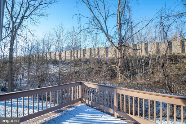 a view of roof deck with wooden fence and wooden fence