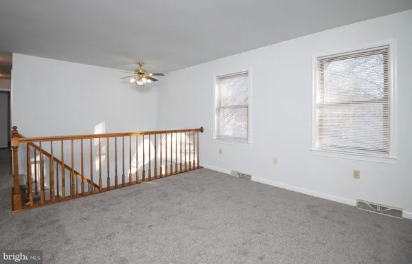 a view of a livingroom with a ceiling fan and window