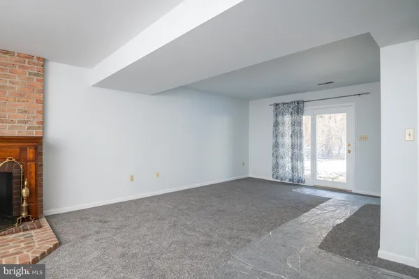 a view of an empty room with a fireplace