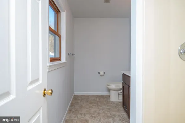 a bathroom with a toilet and a window