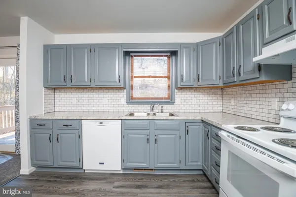 a kitchen with a sink cabinets and window