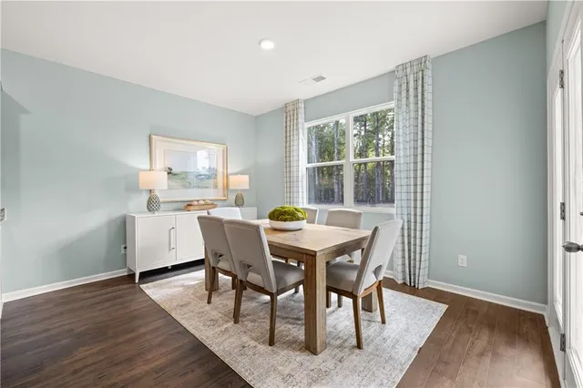 a dining room with furniture and wooden floor