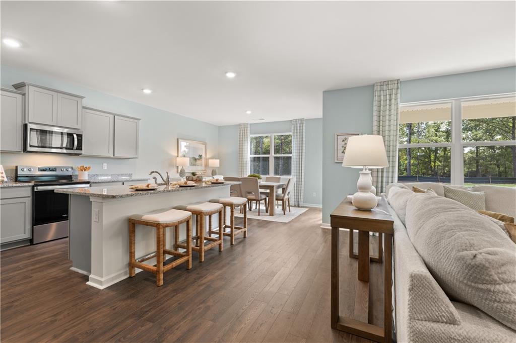 1080 Amerson Street Buckhead, GA 30625 - Photo 13 of 51 a living room with stainless steel appliances granite countertop furniture a fireplace a flat screen tv and a kitchen view
