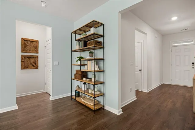 an empty room with wooden floor closet and window