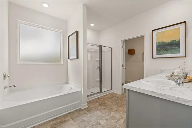 a bathroom with a tub a sink and mirror