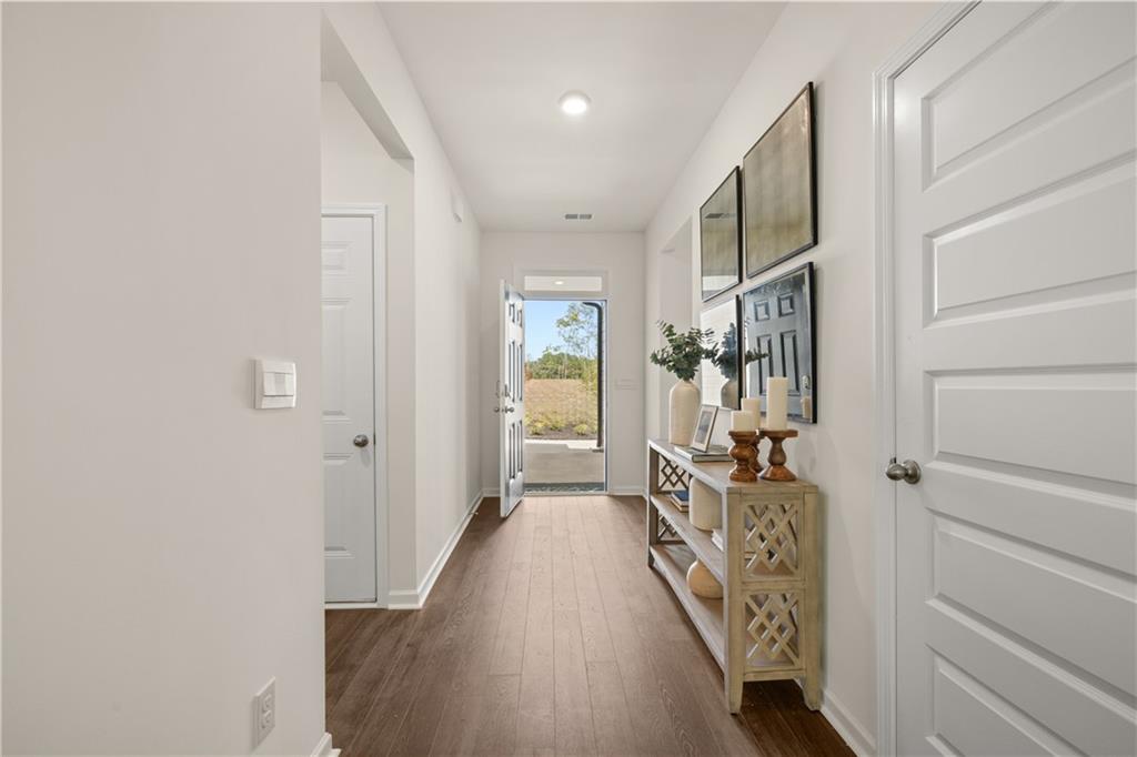 1080 Amerson Street Buckhead, GA 30625 - Photo 3 of 51 a hallway with wooden floor windows and stairs