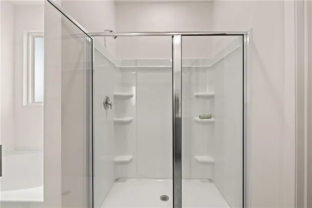 a bathroom that has a glass shower door