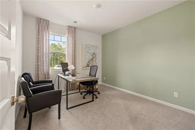 a view of a workspace with furniture