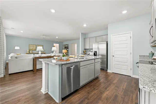 a kitchen with a sink cabinets and wooden floor