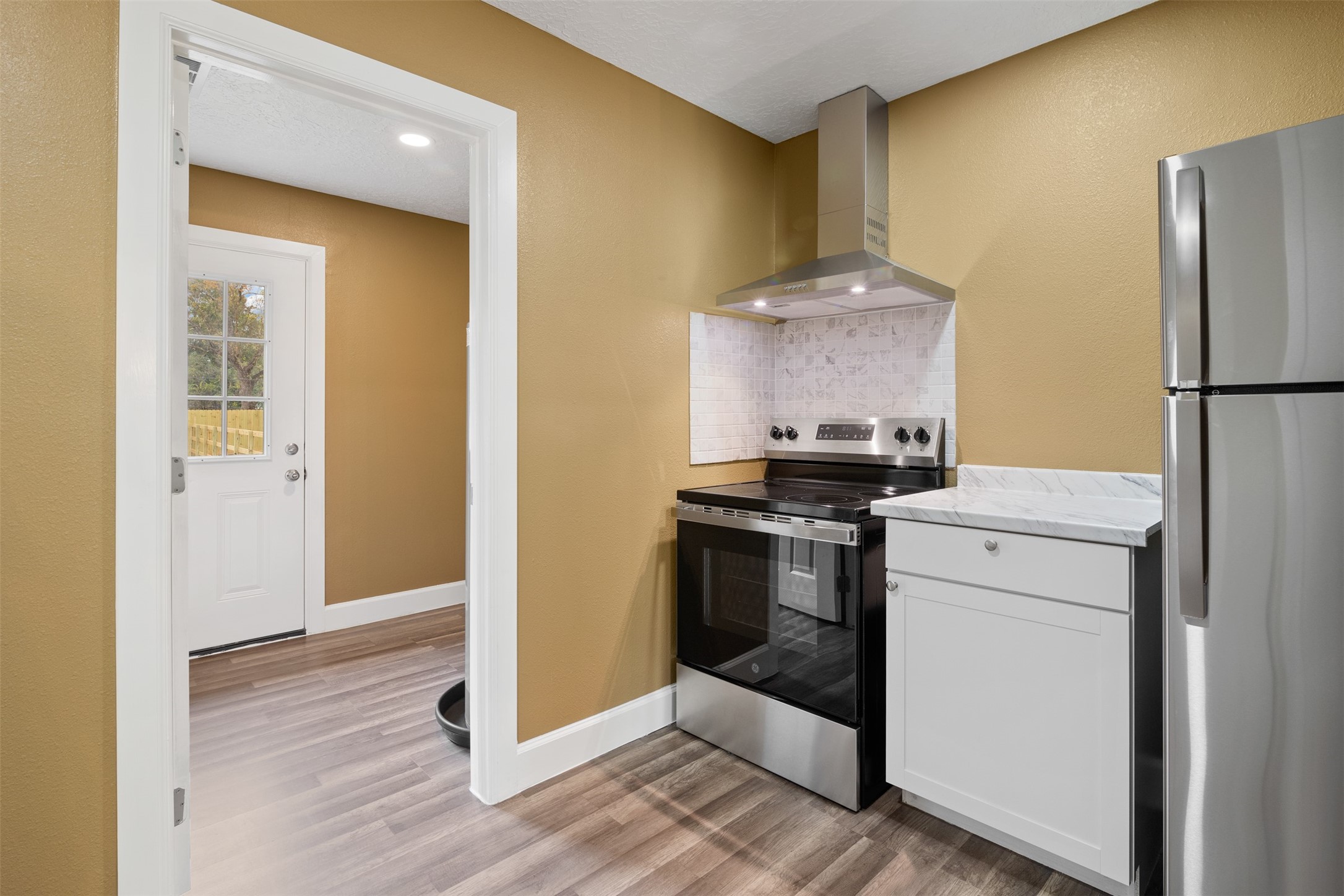 38210 Green Willow Street, Unit A Magnolia, TX 77355 - Photo 6 of 16 a kitchen with a refrigerator and a stove