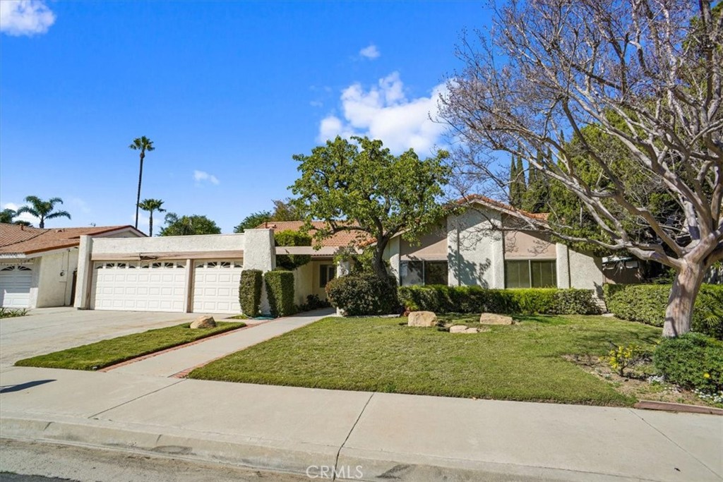 17813 Lemarsh Street Northridge, CA 91325 - Photo 1 of 19 a front view of a house with a garden and tree