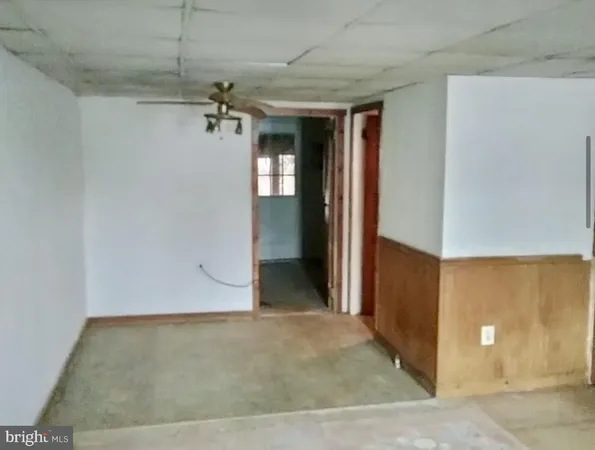 a view of a hallway with wooden shelves