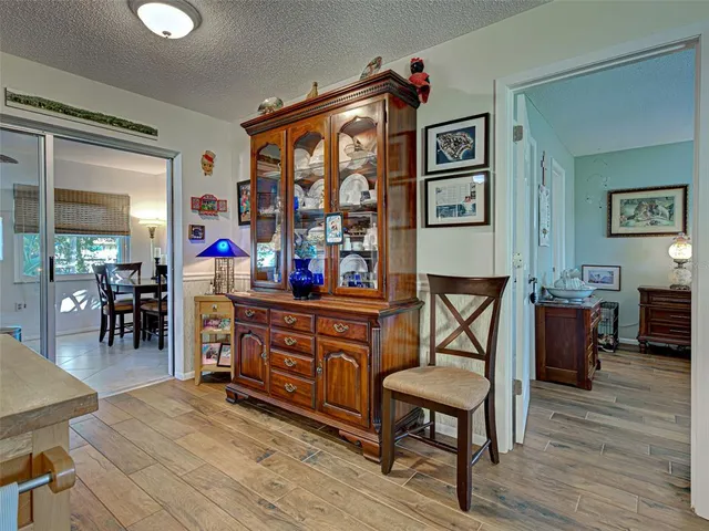 a view of a workspace with furniture window and wooden floor