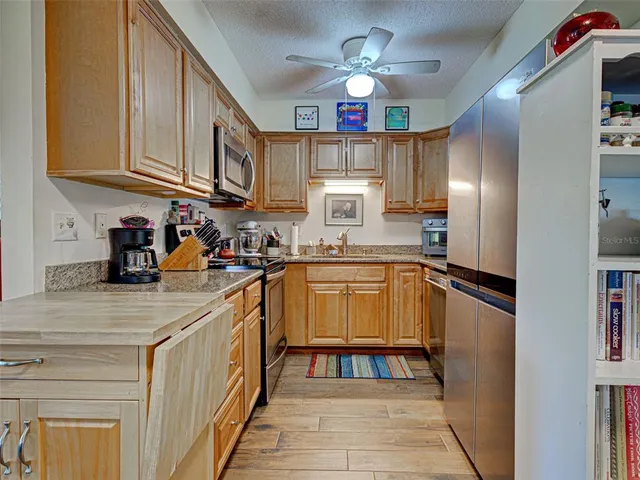 a bathroom with a granite countertop sink a toilet and shower