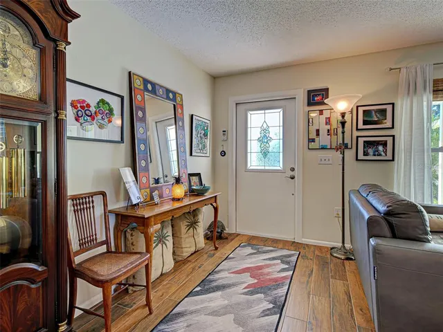 a kitchen with stainless steel appliances granite countertop a refrigerator a oven a sink dishwasher and white cabinets with wooden floor