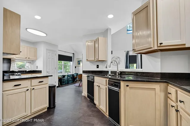 a kitchen with stainless steel appliances granite countertop a stove sink and cabinets