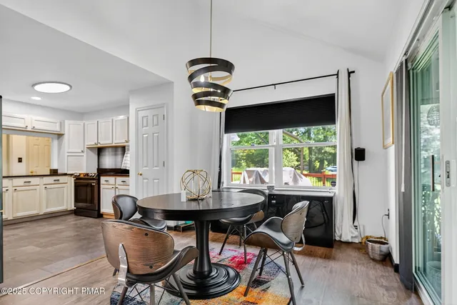 a kitchen with a stove a refrigerator and a table