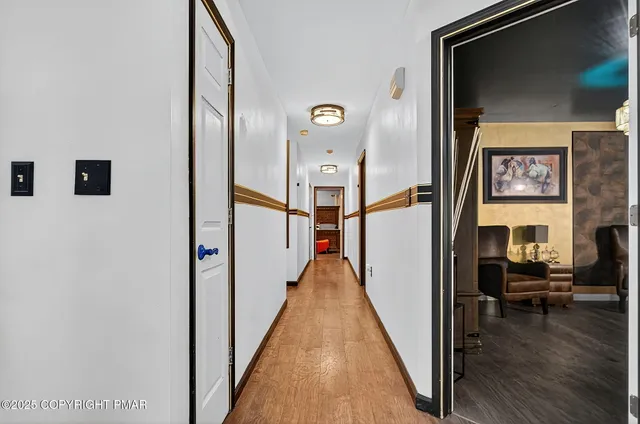 a view of a hallway with a livingroom and a fireplace