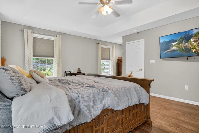 a bedroom with a bed and a painting on the wall