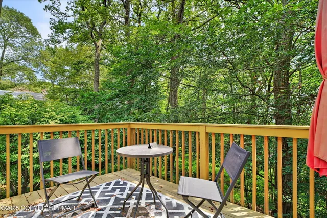 a view of a chairs and table in the roof deck