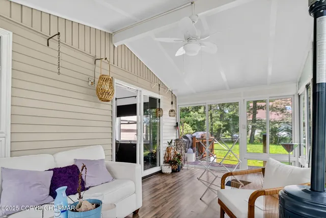 a living room with fireplace furniture and a large window