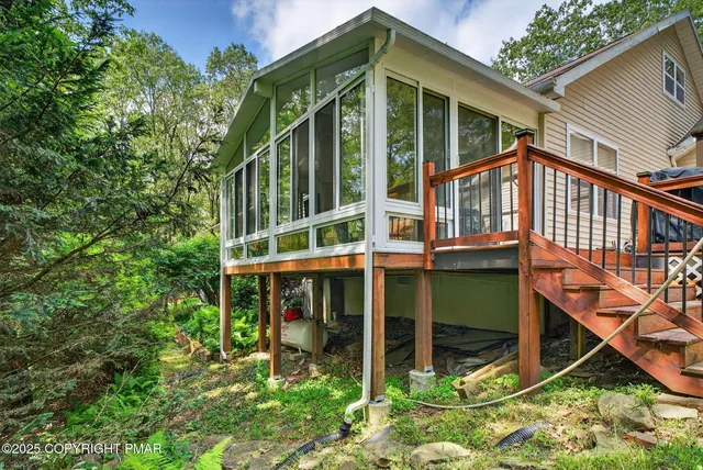 a view of a house with a yard and lawn chairs