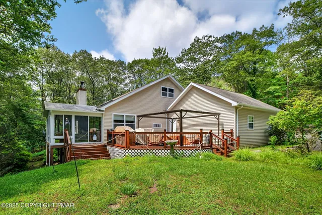 a view of a house with yard and sitting area