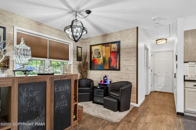 a very nice looking living room with a large window and a chandelier