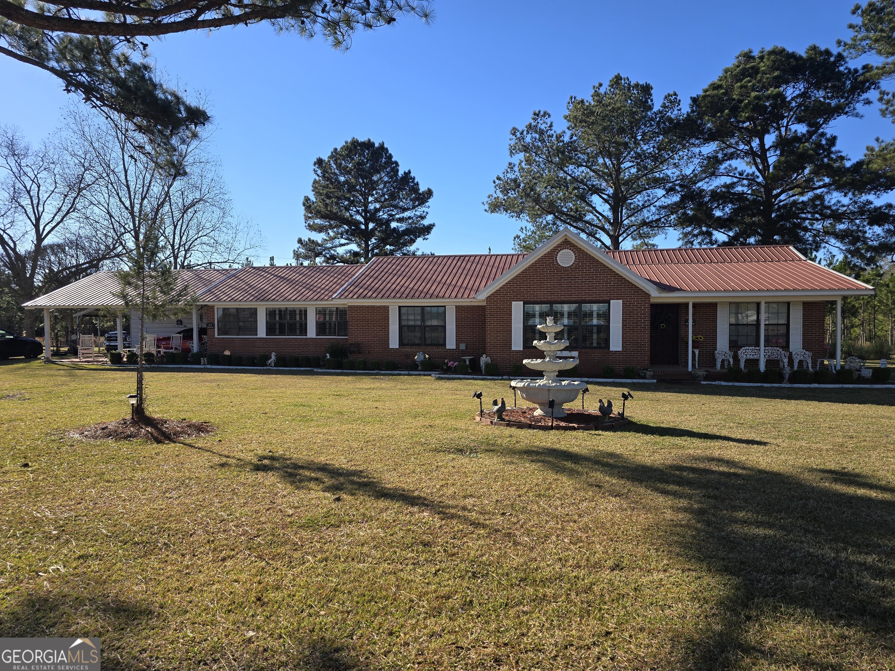 479 Mitchell Loop Bluffton, GA 39824 - Photo 1 of 51 a front view of a house with swimming pool and porch