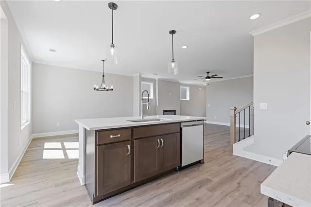 a kitchen with a sink cabinets and wooden floor