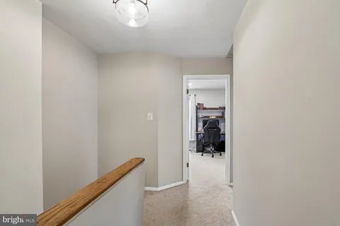 a view of hallway with bathroom