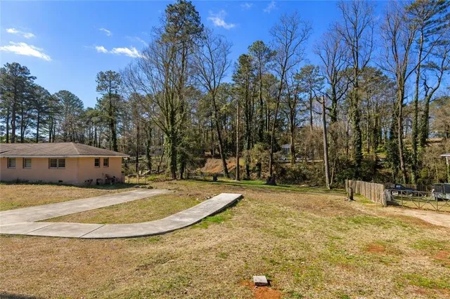 a view of white house with a yard