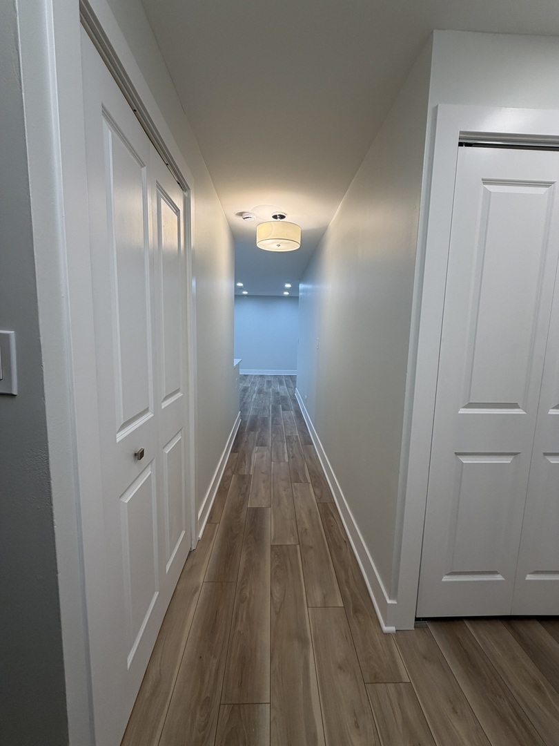 452 West Aldine Avenue, Unit 427 Chicago, IL 60657 - Photo 3 of 10 a view of a hallway with wooden floor