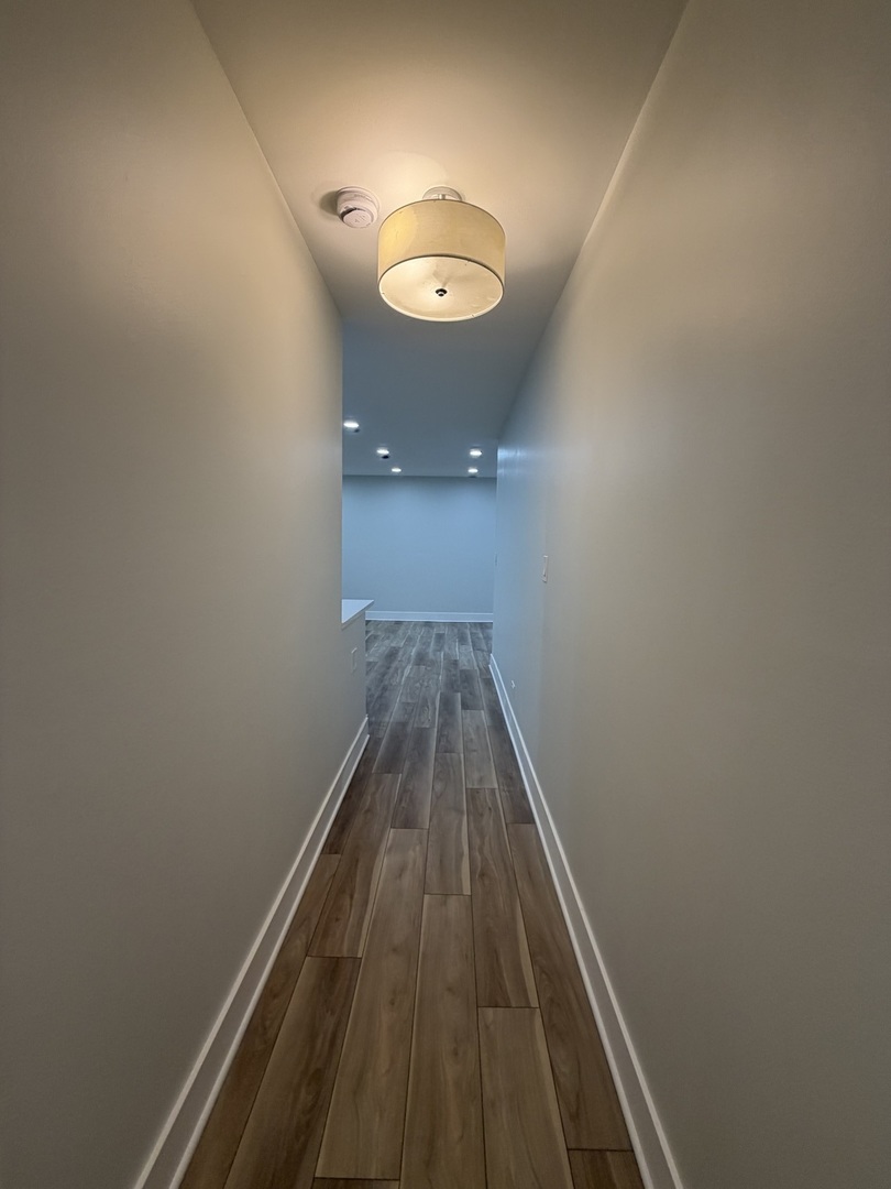 452 West Aldine Avenue, Unit 427 Chicago, IL 60657 - Photo 6 of 10 a view of a hallway with wooden floor