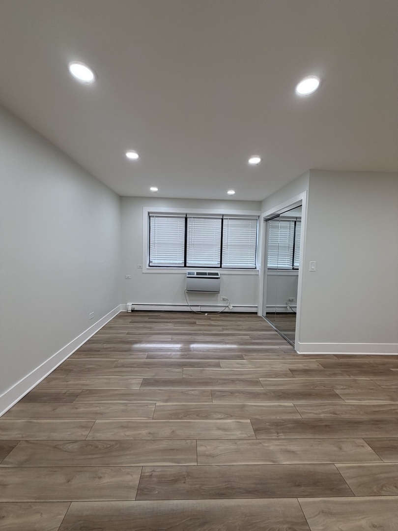 452 West Aldine Avenue, Unit 427 Chicago, IL 60657 - Photo 7 of 10 a view of empty room with wooden floor