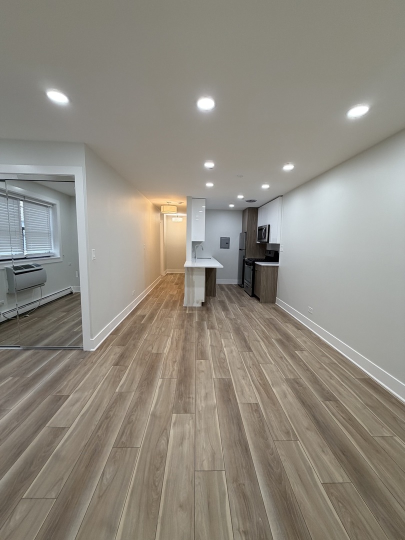 452 West Aldine Avenue, Unit 427 Chicago, IL 60657 - Photo 8 of 10 a view of kitchen with wooden floor and electronic appliances