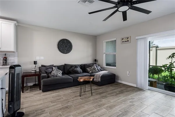 a living room with furniture and a wooden floor