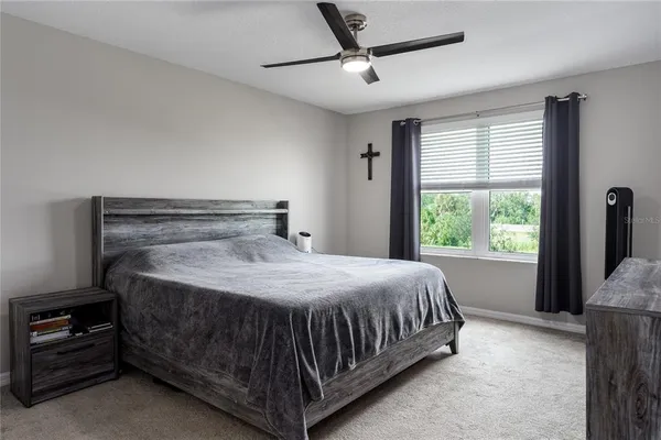 a bed sitting in a bedroom next to a window