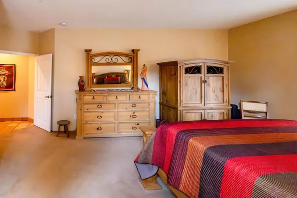 a bedroom with a bed and a television