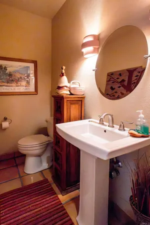 a bathroom with a toilet a sink and mirror