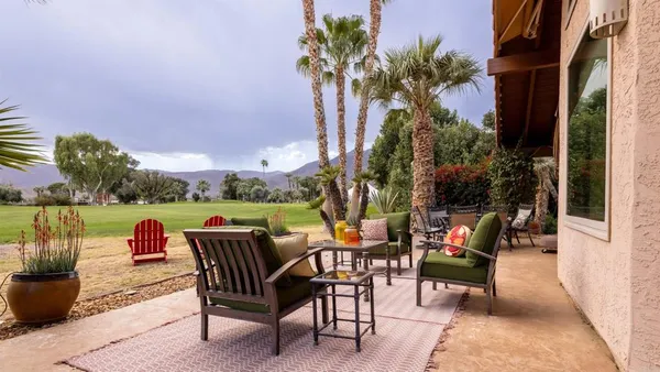 a backyard of a house with outdoor seating