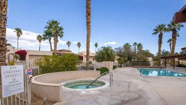 a swimming pool with outdoor seating and yard