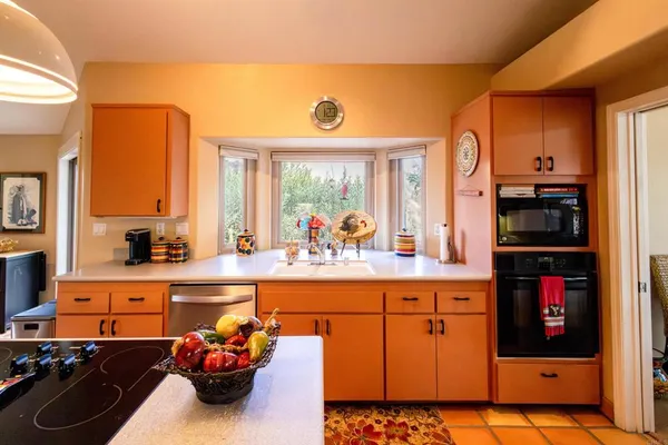 a kitchen with stainless steel appliances a stove a refrigerator and cabinets