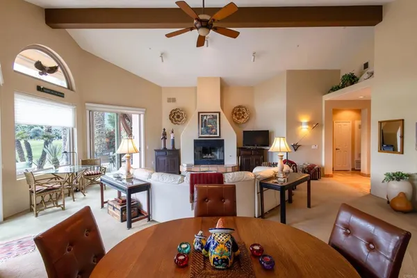 a living room with fireplace furniture and a large window