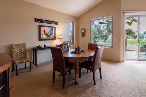 a dining room with furniture and window