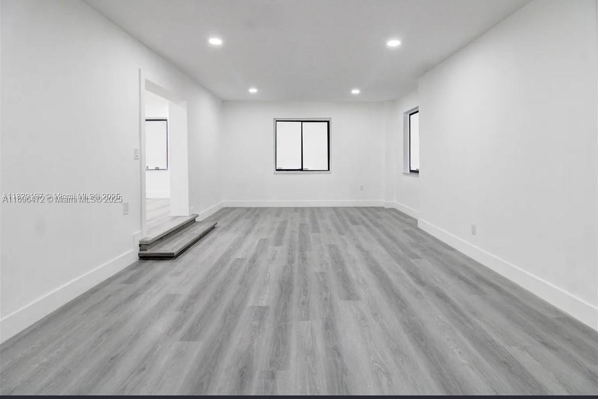 13885 Northwest 5th Avenue North Miami, FL 33168 - Photo 11 of 14 an empty room with wooden floor and windows